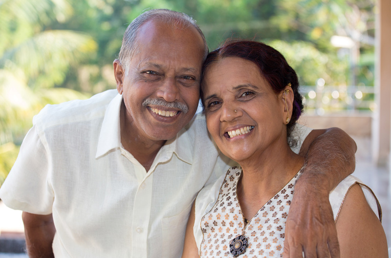 A smiling couple embracing.