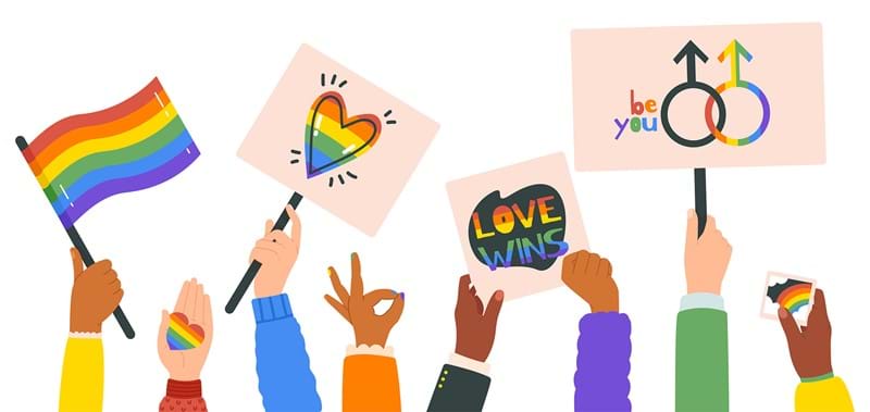 An illustration of a ground of people holding up pride flags and signs. 