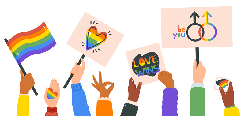 An illustration of a ground of people holding up pride flags and signs. 